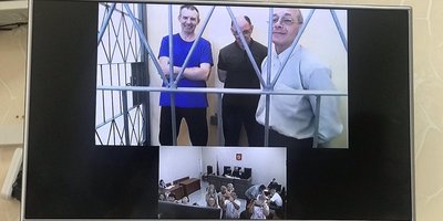 From left to right: Vladimir Sakada, Yevgeniy Zhukov and Vladimir Maladyka attend the appeal hearing via video conferencing