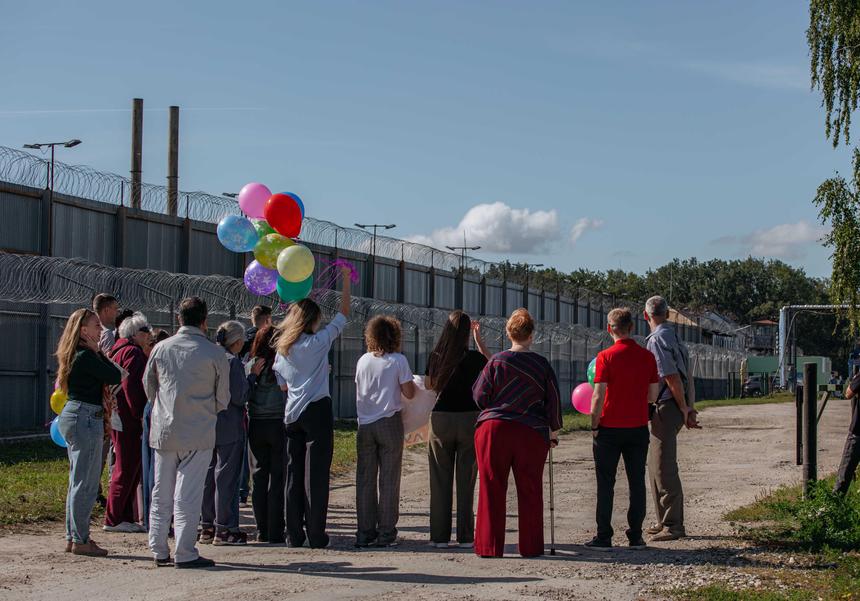 Friends meet Vladimir at the penal colony exit
